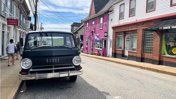 An antique Dodge truck sits on the side of the road amidst colourful buildings in Lunenburg, Nova Scotia Facts