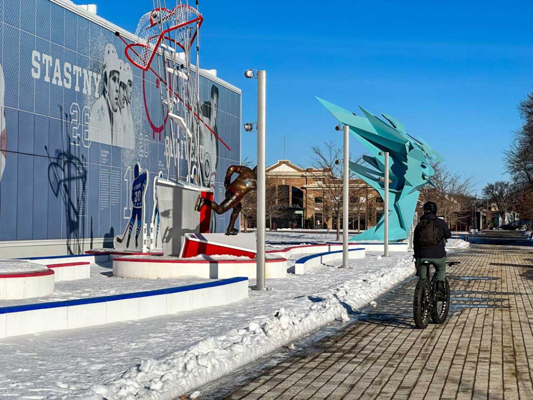 A man rides a fat bike through hockey row on the edge of Quebec City