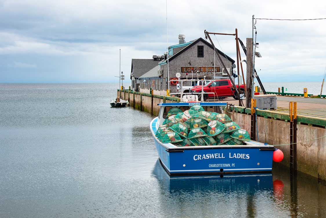 A fishing boat floats at the wharf at Victoria-by-the-Sea, PEI