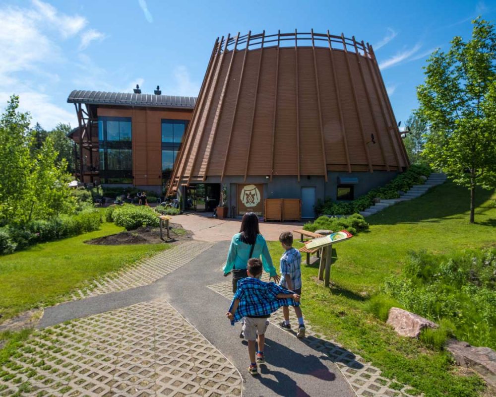 A family walk toward an Indigenous hotel in Quebec City