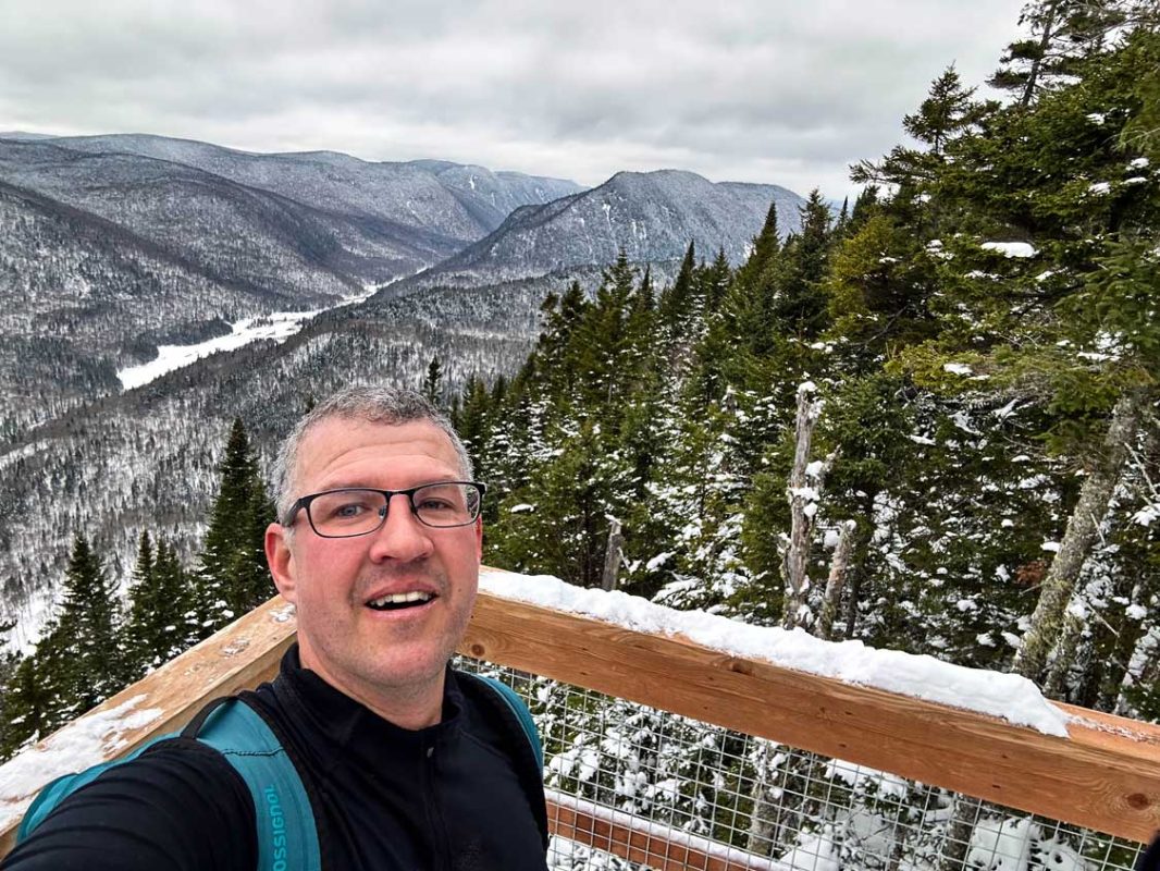 Kevin Wagar takes a selfie from a viewpoint overlooking Jacques Cartier National Park