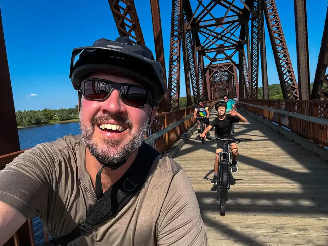 Kevin Wagar and his son biking across the Bill Thorpe Bridge in Fredericton