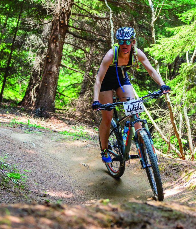 Woman mountain biking at Club Plein Air de Caraquet in the Acadian Peninsula