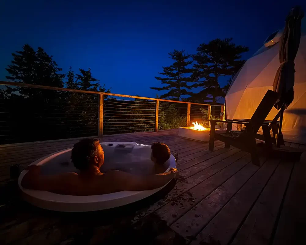 Kevin Wagar and his son Dylan stargazing from a hot tub in Nova Scotia