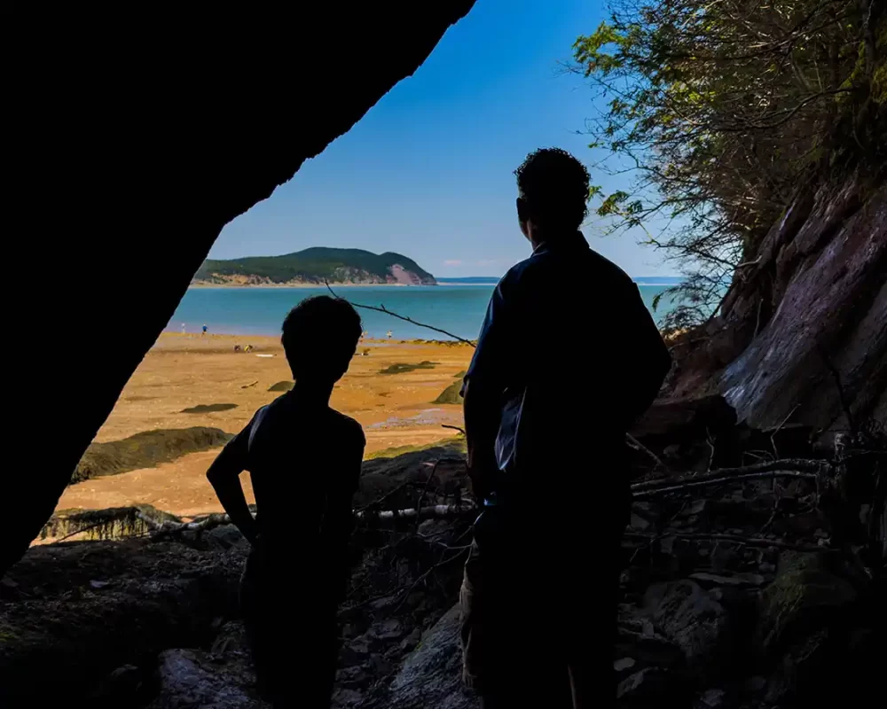 Kevin Wagar and his son look out from a sea cave in Fundy National Park