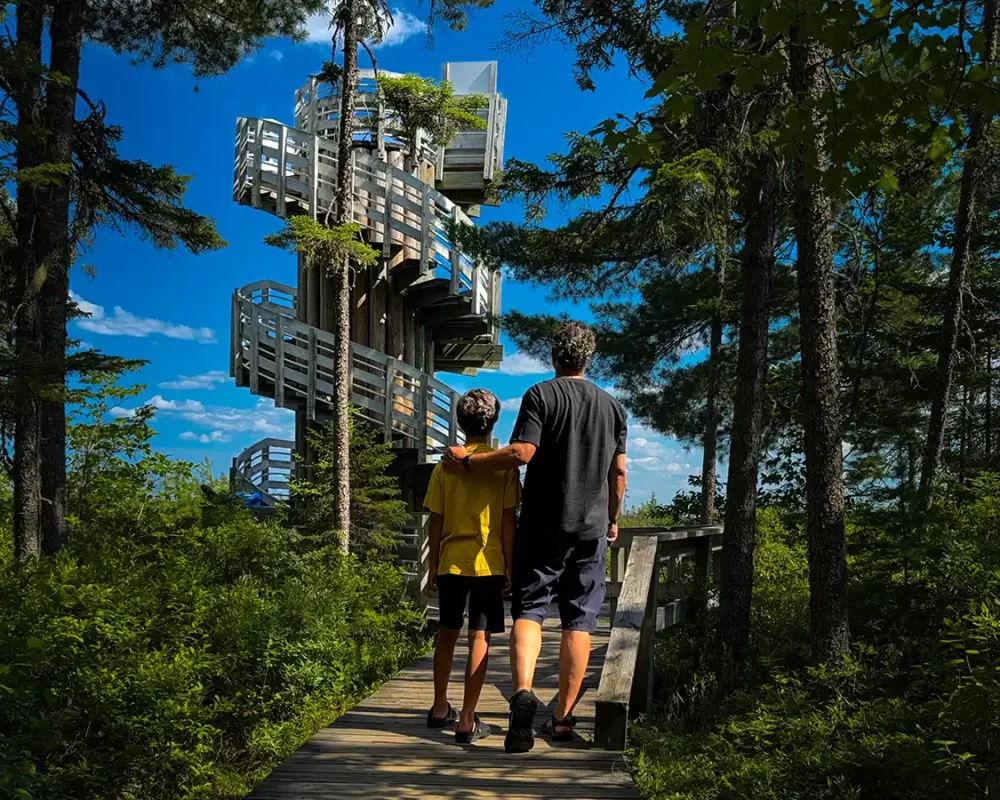 Kevin Wagar and his son walk toward an observation deck in Kouchibouguac National Park