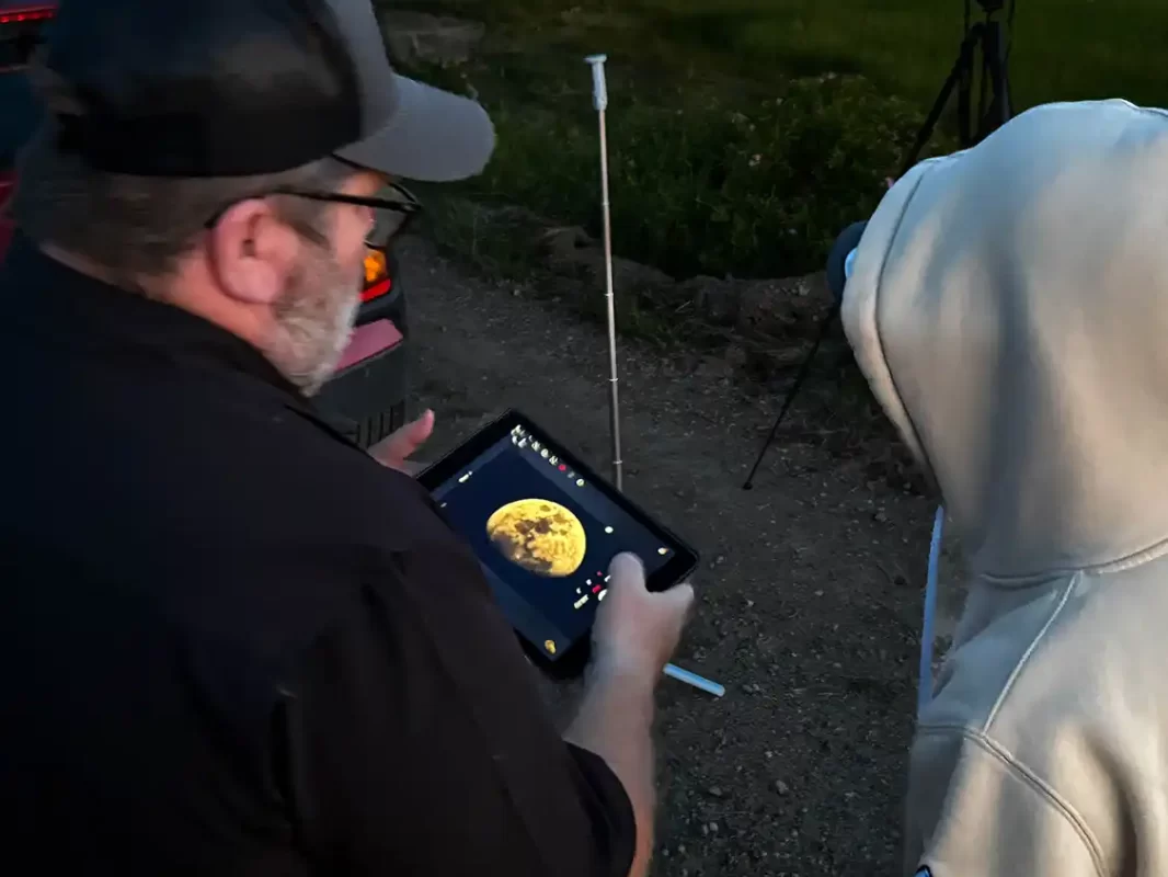 Stephane Picard shows Dylan Wagar a photo of the moon on his tablet